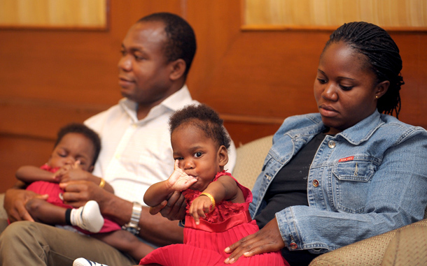 Nigerian parents Comfort Adugbe (R) and Emmanuel Adugbe respectively hold daughters Peace and Patience, recently separated 8-month old conjoined twins, at a press meet in Bangalore. Peace and Patience were operated last month by a team of 24 medical personnel. The twins, who were joined at the abdomen, sharing liver and intestine, and are called omphalopagus, are set to fly home to Nigeria in the evening. (AFP)