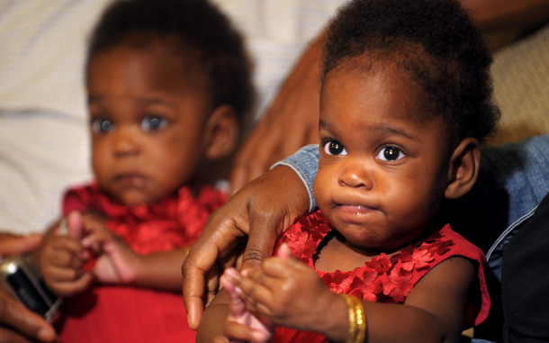 Recently separated 8-month old conjoined Nigerian twins Peace (L) and Patience sit with their parents at a press meet in Bangalore. Peace and Patience were operated last month by a team of 24 medical personnel. The twins, who were joined at the abdomen, sharing liver and intestine, and are called omphalopagus, are set to fly home to Nigeria in the evening. (AFP)