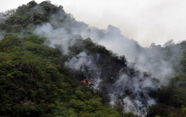 Fire and smoke rises from the wreckage of a passenger plane which has crashed in The Margalla Hills on the outskirts of Islamabad. A Pakistani passenger plane with 150 people on board crashed in a ball of flames in densely wooded hills while trying to land in Islamabad during bad weather, aviation officials said. (AFP)