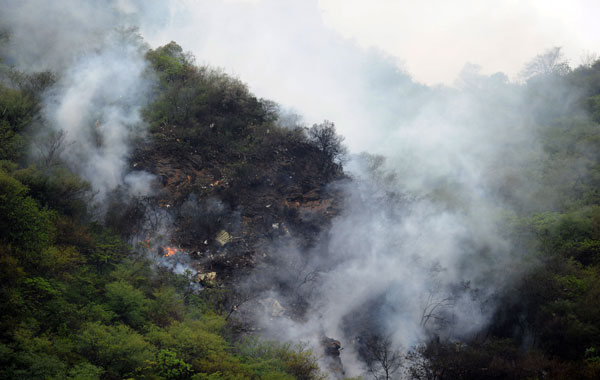 Fire and smoke rises from the wreckage of a passenger plane which has crashed in The Margalla Hills on the outskirts of Islamabad .  A Pakistani passenger plane with 150 people on board crashed in a ball of flames in densely wooded hills while trying to land in Islamabad during bad weather, aviation officials said. (AFP)