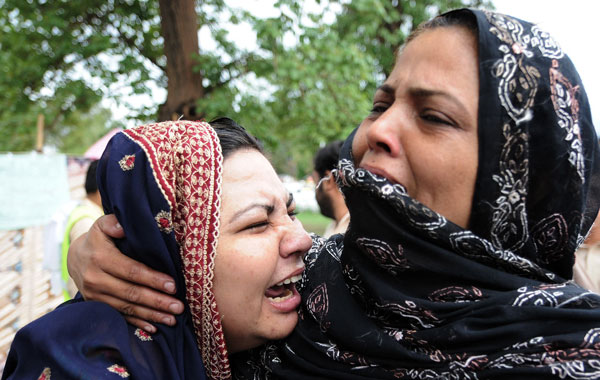 Smoke rises in the distant hills as rescue workers begin their climb of the Margalla Hills near Islamabad, Pakistan. So far at least 30 people are known to have perished in the crash. Also five survivors have been airlifted to hospitals. (EPA)