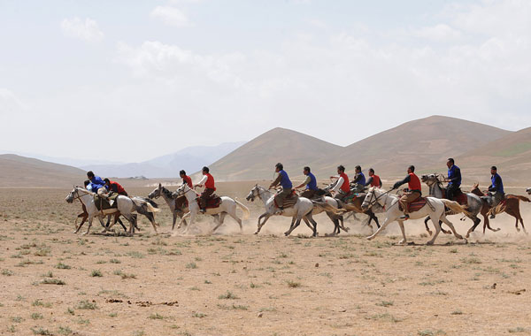 Afghan horsemen compete for the goat carcass during a game of buzkashi in Afghanistan. (AFP)