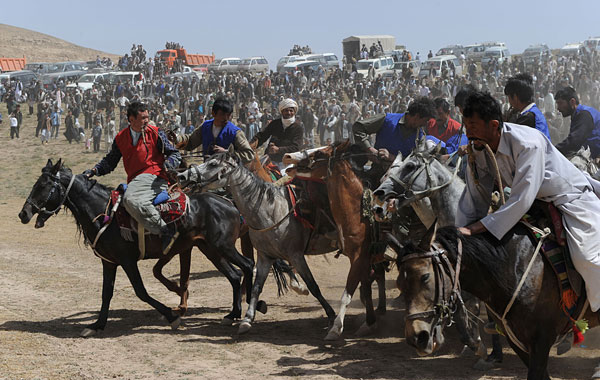 Afghan horsemen compete for the goat carcass during a game of buzkashi in Afghanistan. (AFP)