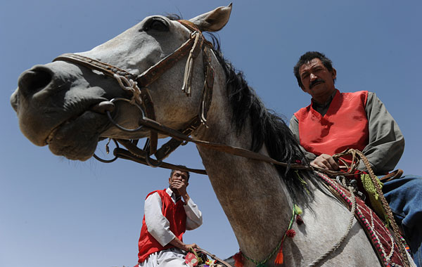 Afghan horsemen compete for the goat carcass during a game of buzkashi in Afghanistan. (AFP)