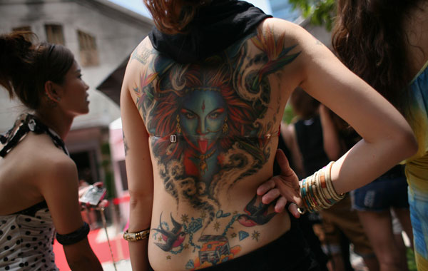 A Taiwanese woman displays her body tattoo at the International Tattoo Festival in Taipei. (AP)