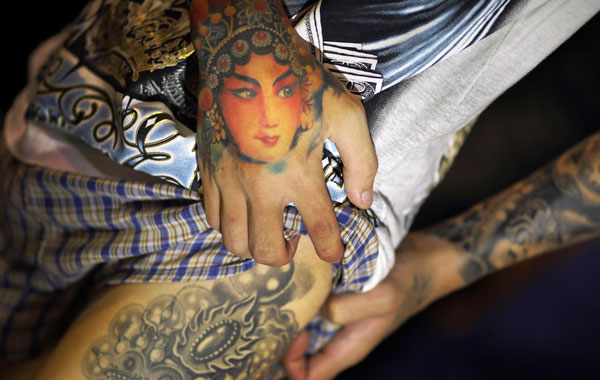 A young Taiwanese man displays his Chinese styled tattoos at the International Tattoo Festival in Taipei. (AP)