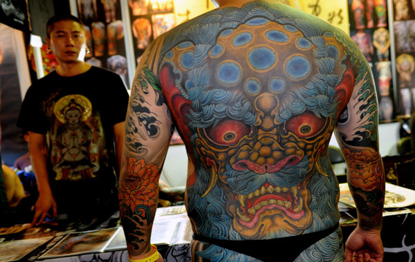 A man shows off his tattoos during the Taiwan International Tattoo Convention at Huashan park in Taipei. (AFP)