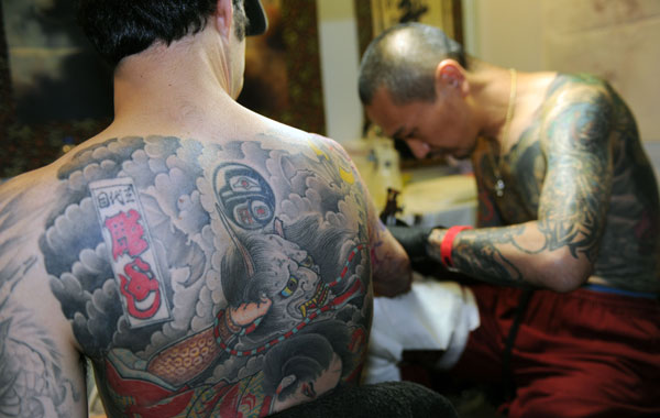 A man gets a tattoo on his hand during the Taiwan International Tattoo Convention at Huashan park in Taipei. (AFP)