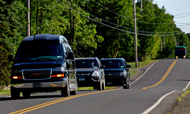 A van carrying Hillary Clinton, and other cars roll along River Road in Rhinebeck N.Y.on the way to Chelsea Clinton's wedding Saturday afternoon. (AP)