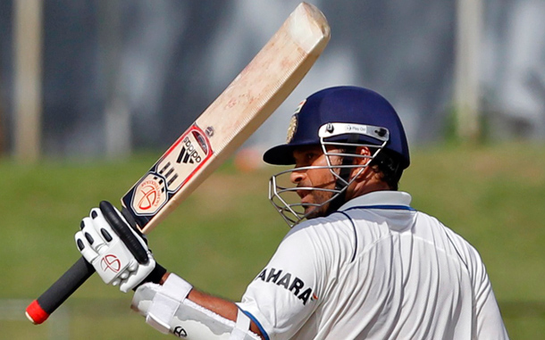 India's Sachin Tendulkar raises his bat to celebrate scoring his half century against Sri Lanka during the third day of their second test cricket match in Colombo. (REUTERS)