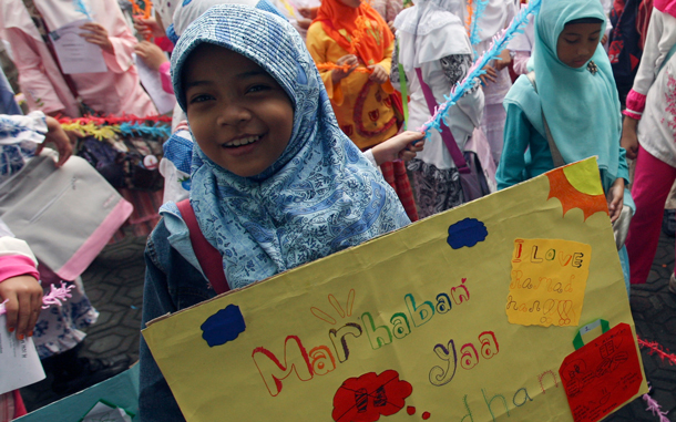 An Indonesian Muslim student holds a poster during a rally for Ramadan in Jakarta, Indonesia. Ramadan, the holy fasting month, is expected to begin on Wednesday, Aug. 11. Indonesia is the world's most populous Muslim nation. (AP)