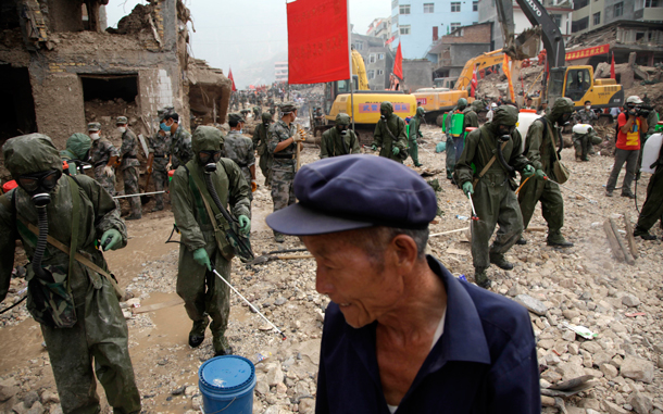 Chinese soldiers disinfect an area after a mud slide swept into the town of Zhouqu in Gannan prefecture of northwestern China's Gansu province. The disaster in China's Gansu province was caused when a debris-blocked swollen river burst, swamping entire mountain villages. (AP)