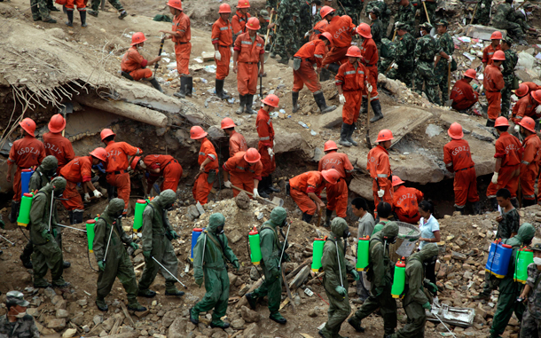 Rescue workers search for victims after a mud slide swept into the town of Zhouqu in Gannan prefecture of northwestern China's Gansu province. The disaster in China's Gansu province was caused when a debris-blocked swollen river burst, swamping entire mountain villages. (AP)