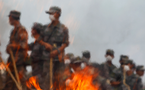 Rescuers set on fire the clothings of victims on a landslide-hit street in Zhouqu County of Gannan Tibetan Autonomous Prefecture, Gansu Province. Engineers battled on Tuesday to drain an unstable lake created by China's deadliest landslide in decades, fearing it could burst and swamp devastated areas where people are still hunting for survivors. (REUTERS)