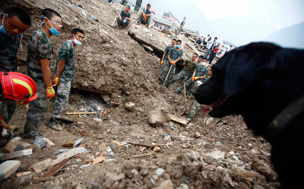 Rescuers find a victim from debris in the landslide-hit Zhouqu County of Gannan Tibetan Autonomous Prefecture, Gansu Province. At least 702 people died in northwestern Gansu province when a torrent of mud and rocks engulfed swathes of the small town of Zhouqu at the weekend, and another 1,042 are missing, an emergency relief official, Tian Baozhong, told reporters there. (REUTERS)