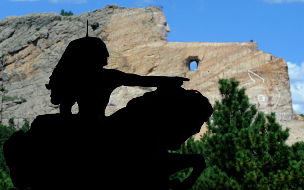 A silhouette of a replica of Chief Crazy Horse pointing as he rides shows what the Crazy Horse Memorial (background) will look like which is being carved out of the granite Thunder Mountain in the Black Hills near Custer, South Dakota. The massive undertaking originally the creation and idea of Polish-American artist and sculptor Korczak Ziokowski who started the undertaking in 1948 might be the largest sculpture in the world measuring when completed at 641 feet (195 m) wide and 563 feet (172 m) high. (EPA)