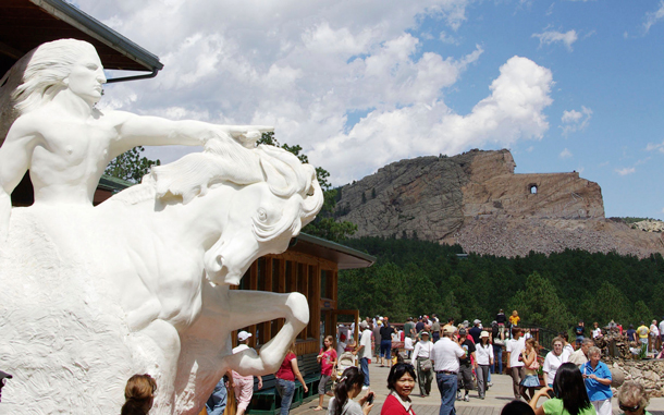 Model of the planned sculpture, left, and the Crazy Horse Memorial, background right, in the Black Hills near Custer, S.D. The memorial being carved in the likeness of Sioux warrior Crazy Horse is intended to honor all American Indians. (AP)