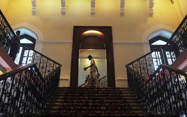 Hotel staff walk through the newly-restored heritage wing of Mumbai's landmark Taj Mahal Palace and Tower hotel is seen before its reopening on August 15. (AFP)