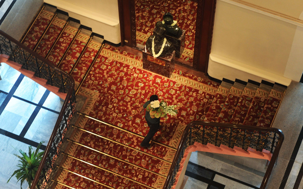 A hotel employee carries flowers in the newly-restored heritage wing of Mumbai's landmark Taj Mahal Palace and Tower hotel is seen before its reopening on August 15. Restoration work on the 105-year old section of the luxury hotel has taken 18 months after it was badly-damaged by fire, shooting and explosions when four heavily-armed Islamist gunmen stormed the building on November 26, 2008. (AFP)