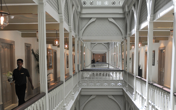 A hotel employee carries flowers in the newly-restored heritage wing of Mumbai's landmark Taj Mahal Palace and Tower hotel is seen before its reopening on August 15. (AFP)