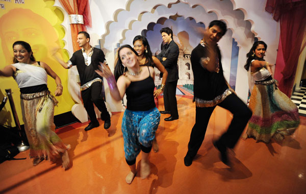 A troupe of Bollywood Axion dancers performs around the wax figure of Indian film star Shah Rukh Khan (C, rear) at Madame Tussauds New York. (AFP)