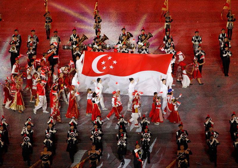 The Singapore flag is carried during the opening ceremony of the inaugural Youth Olympic Games at the Marina Bay floating platform in Singapore. (REUTERS)