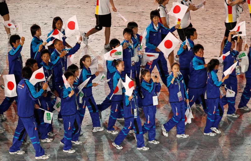 Members of the Japanese delegation arrive for the opening ceremony of the inaugural Youth Olympic Games at the Marina Bay floating platform in Singapore. (REUTERS)