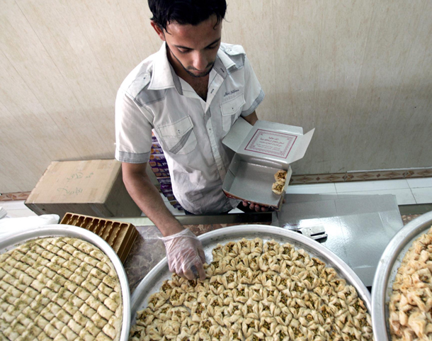 Iraqi sweet shop workers are seen at a sweet shop in Baghdad, Iraq. Sweets are in high demands during the Muslim holly month of Ramadan. Ramadan is one month during which Muslims around the world fast all day from sunrise to sunset. (EPA)