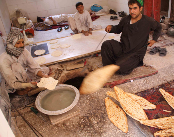 A man sells traditional bread as time to break the Fast approaches, during the Islamic Fasting month of Ramadan in Multan Pakistan. Muslims all over the world are observing the holy month of Ramadan which prohibits food, drinks, smoke and sex from dawn to dusk. (EPA)