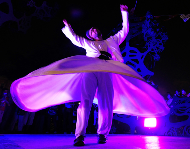 A whirling dervish performs during a Ramadan festival organized by the Fatih municipality in Eminonu, downtown Istanbul. Muslims all over the world are supposed to go without food, drink, smoking and sex from sunrise to sunset during the month of Ramadan in order to purify themselves and concentrate their mind on Islamic teachings. (AFP)