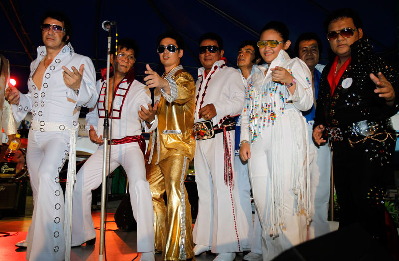 Contestants dressed as Elvis Presley pose before a sing-a-like contest in a mall in Manila. (REUTERS)