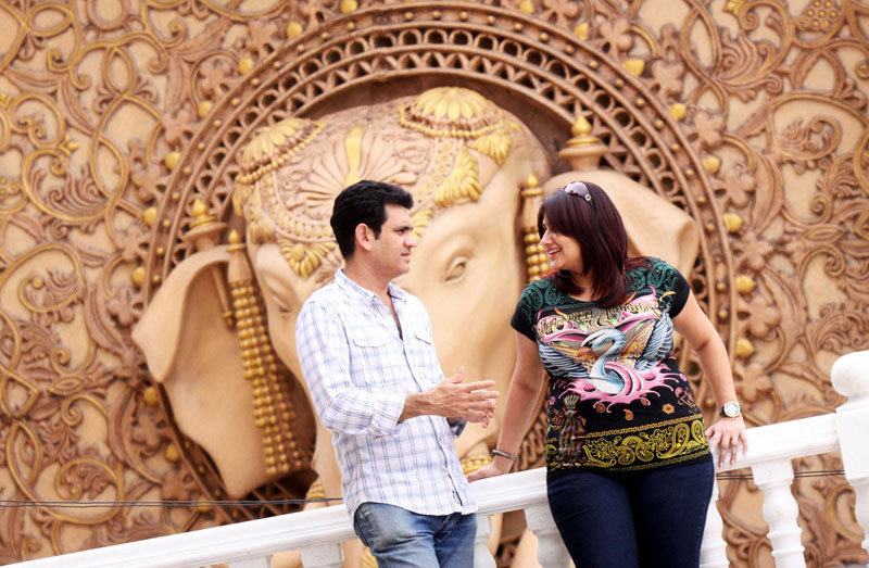 Set designer and art director, Omung Kumar (L) and his wife, production designer Vanita Kumar (R) pose for photographs at the Bollywood theme park, Kingdom of Dreams, in Gurgaon, Haryana state, India. (EPA)