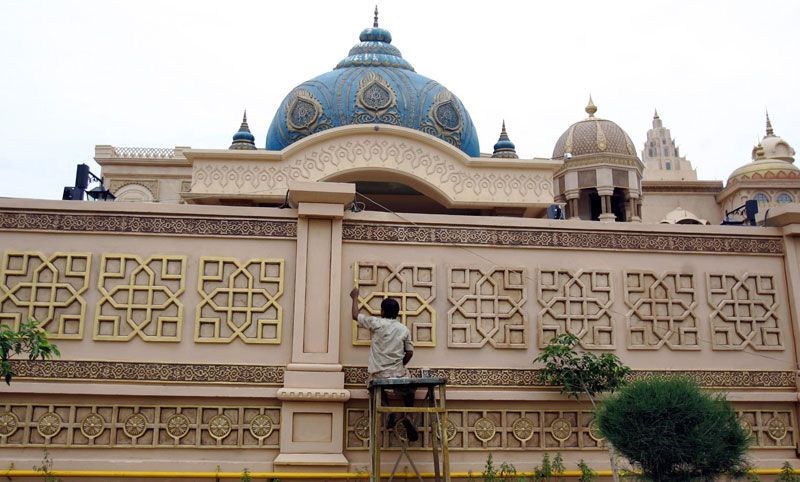 An Indian worker gives final touches to a statue at the Bollywood theme park 'Kingdom of Dreams' in Gurgaon, Haryana state, India. (EPA)