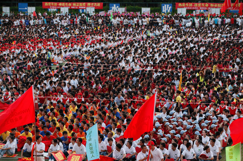 Thousands of Foxconn workers attend a rally to raise morale at the heavily regimented factories inside the Foxconn plant in Shenzhen, south China, Guangdong province. (AP)