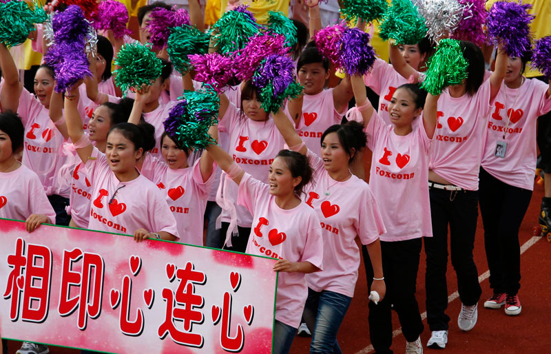 Workers from Foxconn take part in a "Treasure Your Life" rally inside a stadium at a Foxconn plant in the southern Chinese township of Longhau in Guangdong province. (REUTERS)