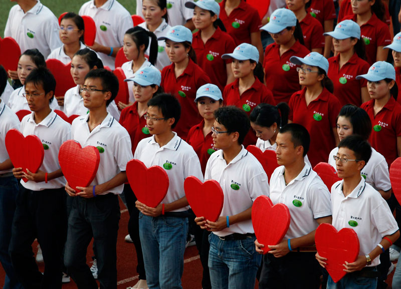 Workers from Foxconn take part in a "Treasure Your Life" rally inside a stadium at a Foxconn plant in the southern Chinese township of Longhau in Guangdong province. (REUTERS)