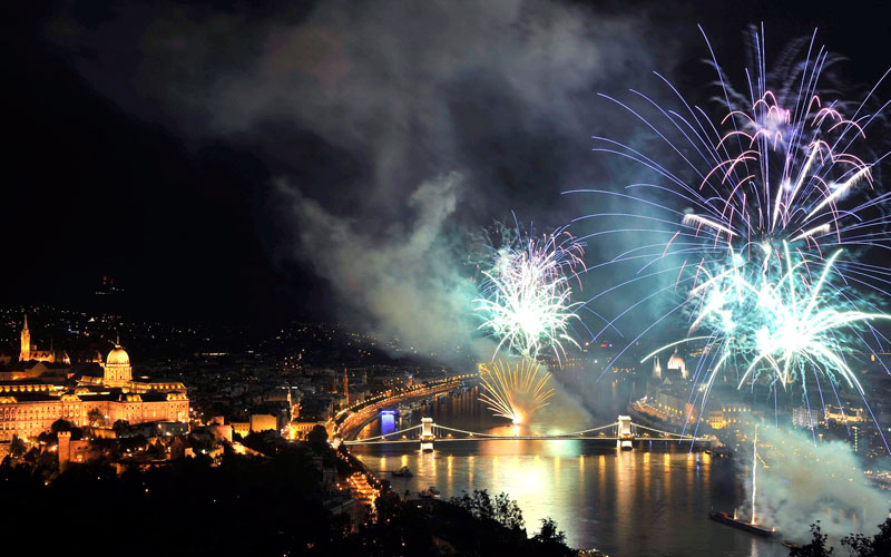 Backdropped by a view of the illuminated Chain Bridge and the Royal Castle (L) on Castle Hill, fireworks fired from barges on the river Danube explode over the river in Budapest, Hungary. (EPA)