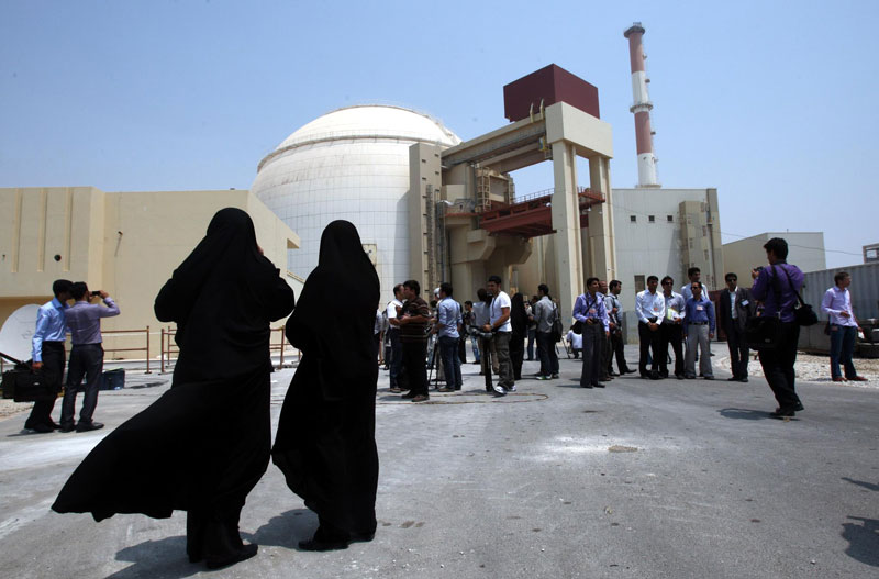 Iranian women security officials of the Bushehr nuclear plant wearing the  Islamic black gown (Chador) look to  media in front of the plant in in Bushehr southern Iran. (EPA)