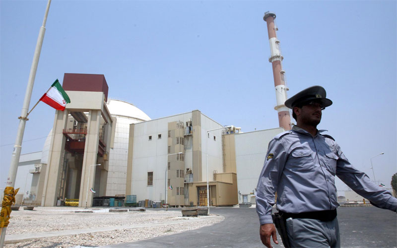 An Iranian security walks in front of the nuclear power plant in Bushehr , southern Iran. (EPA)