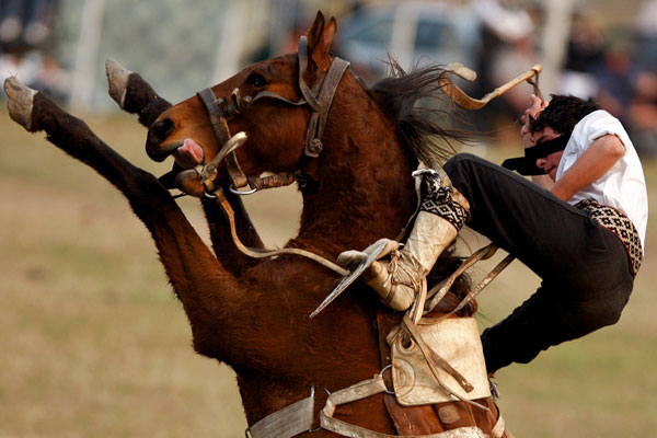 An Argentine gaucho, or cowboy, competes during a rodeo in Jauregui, Argentina. (AP)