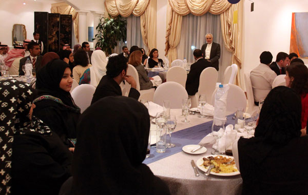 Imam Feisal Abdul Rauf, standing right, addresses guests at an iftar dinner, hosted by the U.S. Embassy's deputy chief of mission Stephanie Williams, seen at center, at the U.S. ambassador's residence in Saar, Bahrain. (AP)