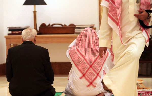 Imam Feisal Abdul Rauf, left, prays during an iftar dinner, hosted by the U.S. Embassy's deputy chief of mission Stephanie Williams, unseen, at the U.S. ambassador's residence in Saar, Bahrain. (AP)