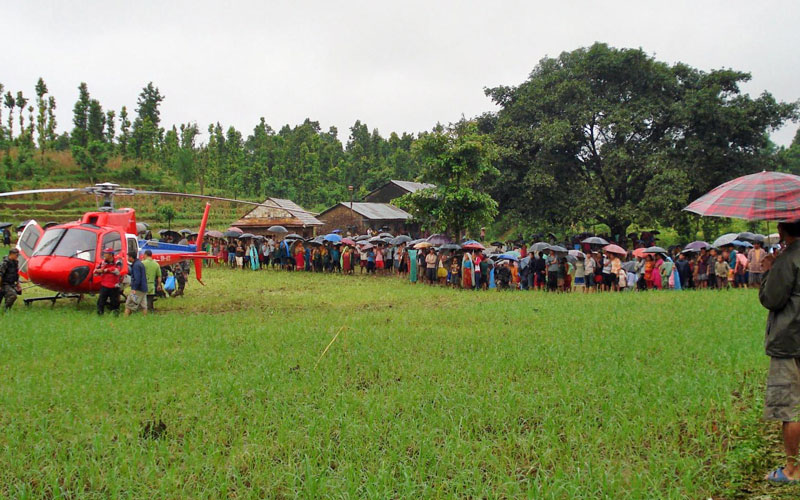 A Nepalese Army handout image showing villagers gathering at the crash site as Nepalese army load the dead bodies of Agni Air plane crash victims at Sikharpur VDC in Makwanpur district southwest in Kathmandu, Nepal, 24 August 2010. Fourteen people were killed when the aircraft crashed in Nepal, the flight's operator confirmed. (EPA)