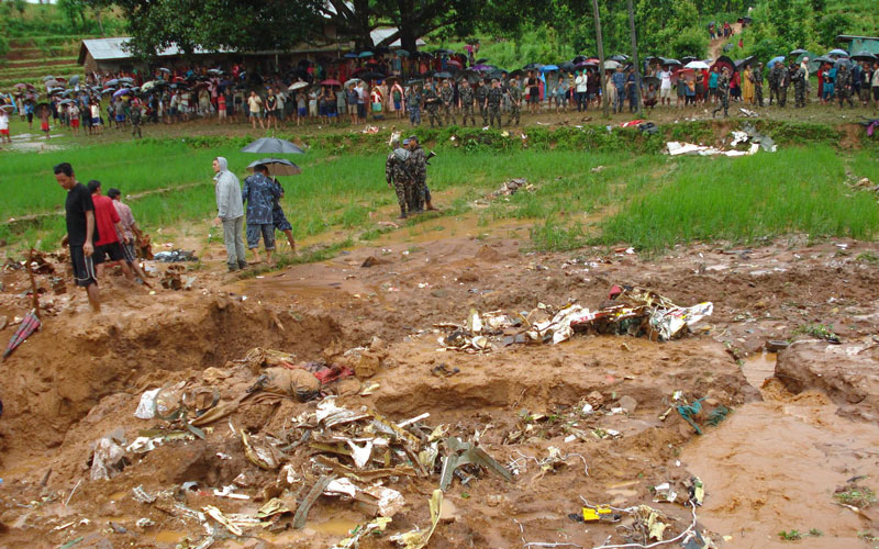 A Nepalese Army handout image showing villagers gathering at the crash site of the Agni Air at Sikharpur VDC in Makwanpur district, southwest in Kathmandu, Nepal. (EPA)