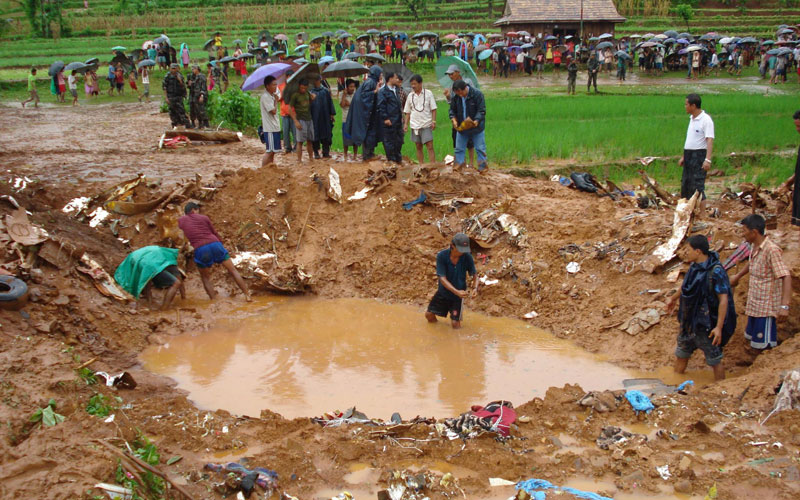 A Nepalese Army handout image showing villagers gathering at the crash site of the Agni Air at Sikharpur VDC in Makwanpur district, southwest in Kathmandu, Nepal. (EPA)