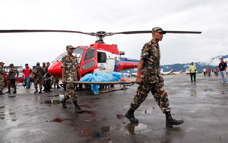 Nepalese army personnel carry remains  of Agni Air plane crash victim brought to Kathmandu Airport in Kathmandu, Nepal. (EPA)