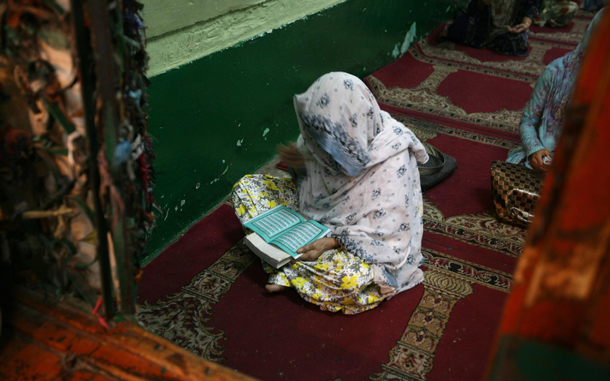 A Kashmiri Muslim woman reads the holy Quran inside the shrine of a Muslim Saint Sheikh Abdul Qadir Jeelani on the 13th day of holy month of Ramadhan in Srinagar, summer capital of Indian Kashmir. The attendance to mosques and shrines increases considerably in the Muslim region during this holy month when people observe fasts from dawn to dusk. (EPA)