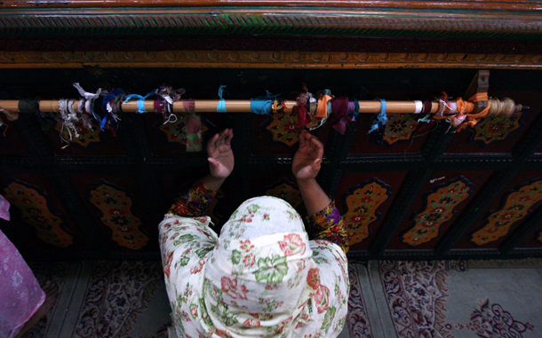 Muslim woman prays inside the shrine of a Muslim Saint Sheikh Abdul Qadir Jeelani on the 13th day of holy month of Ramadhan in Srinagar, summer capital of Indian Kashmir. The attendance to mosques and shrines increases considerably in the Muslim region during this holy month when people observe fasts from dawn to dusk. (EPA)