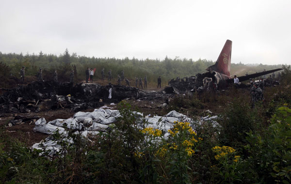In this photo released by China's Xinhua News Agency, a crashed passenger plane lies in Yichun City, northeast China's Heilongjiang Province. (AP)