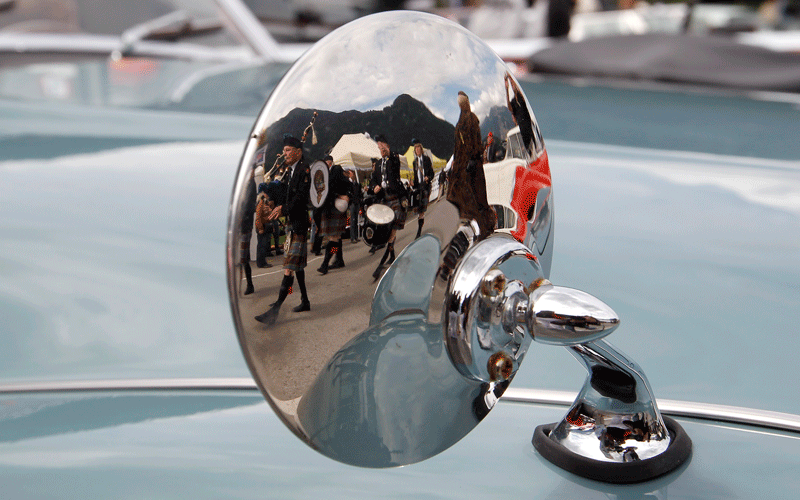 Members of a backpiper band are reflected in the mirror of a vintage Triumph TR3 sports car during the British Car Meeting 2010 in the village of Mollis some 80 kilometres east of Zurich. (REUTERS)